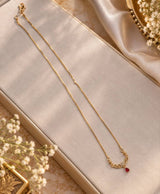 Elegant Gold-Tone Filigree Necklace with Red Teardrop Accent
