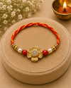 Golden Floral Designer Rakhi with Pearl & Red Beads