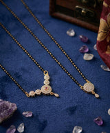Elegant black-beaded mangalsutra set with graceful golden-tone pendants