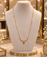 Elegant Gold-Tone Filigree Necklace with Red Teardrop Accent