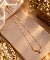Elegant Gold-Tone Filigree Necklace with Red Teardrop Accent