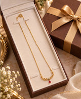 Elegant Gold-Tone Filigree Necklace with Red Teardrop Accent